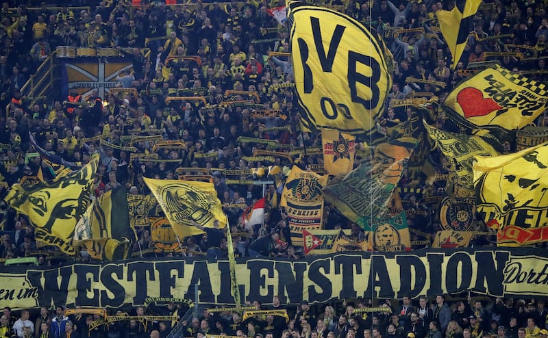 Borussia Dortmund fans wave flags and display banners inside Westfalenstadion. Wolfgang Rattay / Reuters