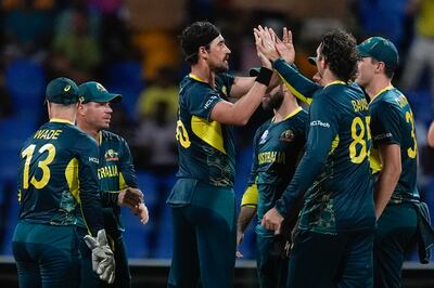 Australia's Mitchell Starc, centre, is congratulated by teammates after taking the wicket of Bangladesh's Tanzid Hasan. AP
