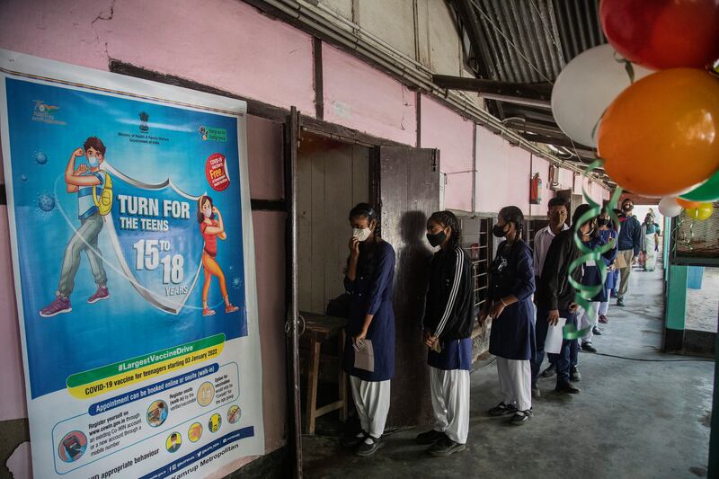 Indian teenagers wait to receive a Covid-19 vaccination at a government school in Gauhati.  India has begun vaccinating teenagers in the age group 15 to 18, as more states enforce tighter restrictions to arrest a surge of infections driven by the Omicron variant.  AP Photo