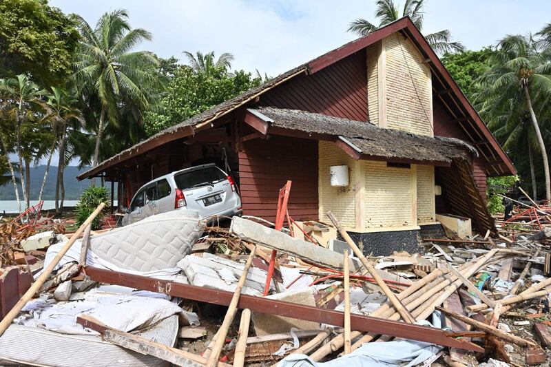 This picture shows a damaged villa and a car at the Mutiara Carita hotel in Carita, Pandeglang, Banten province on December 24, 2018. Another tsunami could strike Indonesia, experts have warned, after a powerful wave caused by a volcanic eruption killed hundreds when it swallowed coastal settlements, taking earthquake-focused disaster monitors by surprise. / AFP / ADEK BERRY
