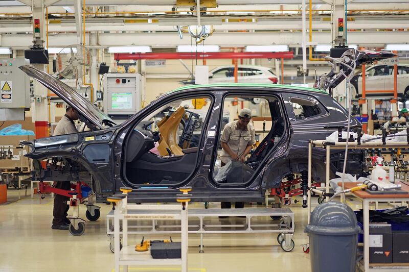 Employees assemble BMW AG X3 sport utility vehicles (SUV) on the production line at a PT Gaya Motor plant in Jakarta, Indonesia, on Wednesday, July 18, 2018. Indonesia is reviewing policies including fiscal, investment and trade to ease the impacts from a trade war, Finance Minister Sri Mulyani Indrawati told reporters in Jakarta last week. Photographer: Dimas Ardian/Bloomberg