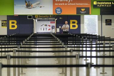 Empty lines ahead of a security gate at Manchester Airport in the UK. Iata's Travel Pass app aims to help facilitate travel in a safe and secure manner that meets Covid-19 screening requirements of countries. Getty