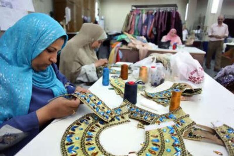 Zizi Mustafa, left, sews jewels and beads on to a collar in the Cairo Opera House's sewing room. The costume makers work around the clock to provide clothing for the ballet and opera productions.