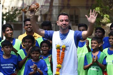 Former Spanish footballer Xavi Hernández reacts during the ground breaking ceremony of an astro-turf (artificial turf) football pitch, in Mumbai on March 18, 2019. Hernández, a FIFA World Cup winner with Spain in 2010, is the first global ambassador for the Generation Amazing programme of the Supreme Committee for Delivery & Legacy (SC)– the organisation responsible for delivering the infrastructure required for the 2022 FIFA World Cup. / AFP / Indranil MUKHERJEE