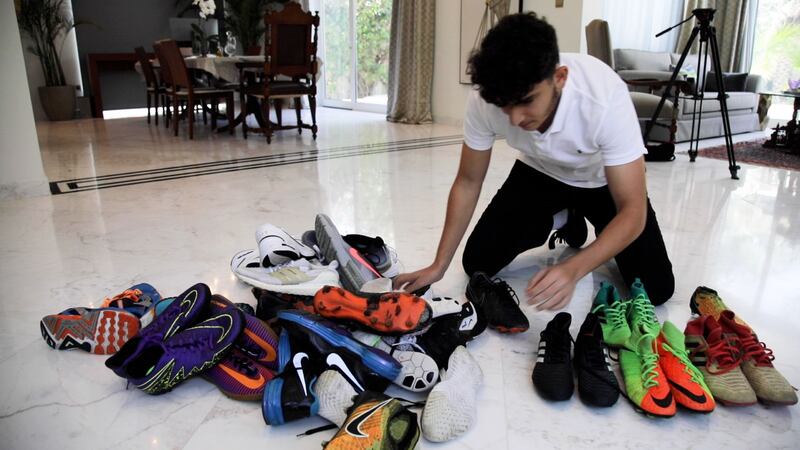 Dubai pupil Ahmad Ghandour, 17, collects used football boots for refugee children in Lebanon. Photo: Suhail Akram / The National