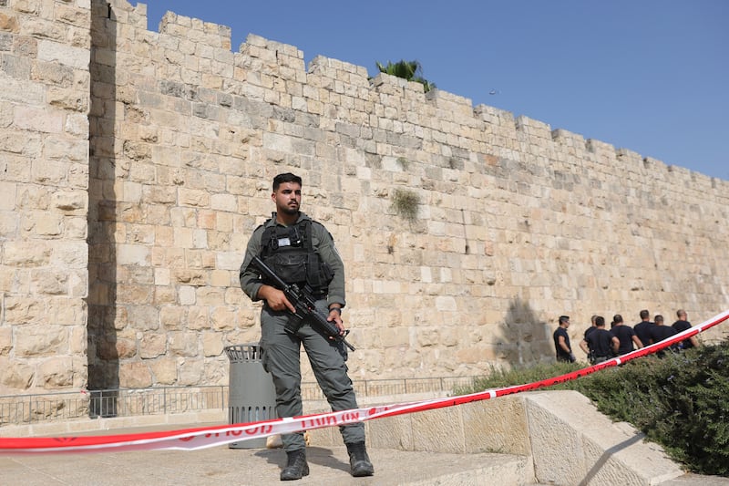 An armed Israeli police officer keeps watch behind a cordon at the scene of a stabbing attack near the Jaffa Gate of Jerusalem's Old City. EPA
