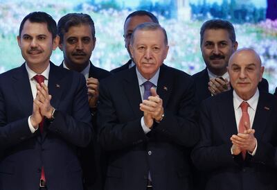 President Recep Tayyip Erdogan, centre, with Istanbul mayoral candidate Murat Kurum, left, and Ankara mayoral candidate Turgut Altinok, right, at the AKP Congress Centre in the Turkish capital. AFP