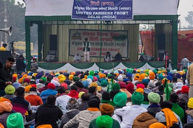 Indian farmers listen to a speaker at a protest against new farm laws on the Delhi-Haryana state border. Getty Images 