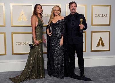 Pippa Ehrlich, left, and James Reed, right pose in the press room with the award for best documentary feature for "My Octopus Teacher" with Marlee Matlin, center, at the Oscars on Sunday, April 25, 2021, at Union Station in Los Angeles. (AP Photo/Chris Pizzello, Pool)