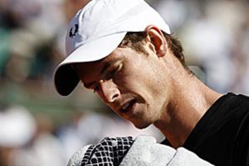 Andy Murray wipes his face during his quarter-final defeat to Fernando Gonzalez.