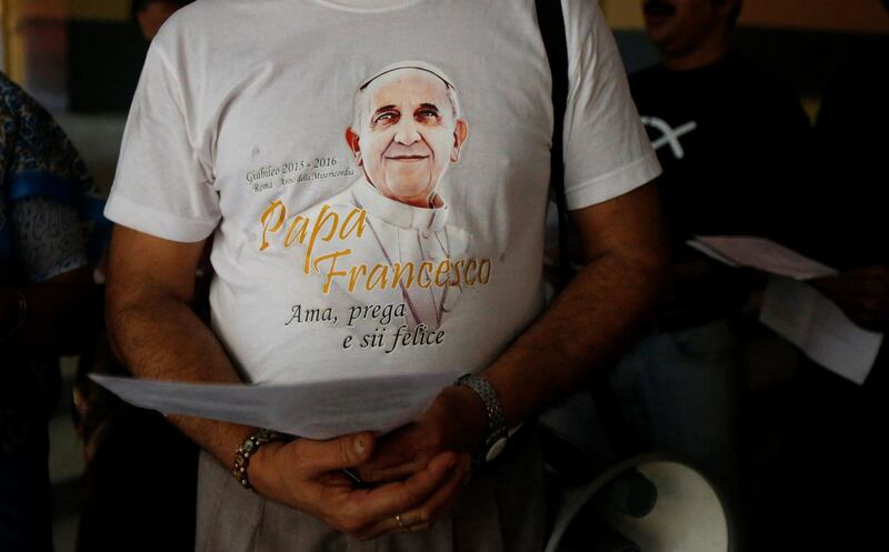 A man wearing a T-shirt with an image of Pope Francis attends Good Friday prayers at a church in Kolkata. Rupak De Chowdhuri / Reuters
