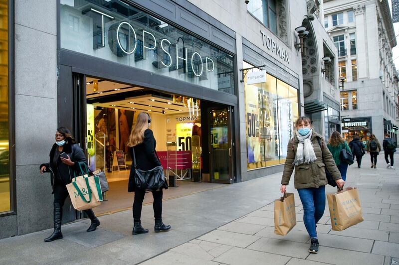 Pedestrians pass a Topshop store in London, U.K., on Wednesday, Dec. 2, 2020. Most of England's retailers are emerging from lockdown, with just over three weeks left until Christmas and the outlook for the industry looking far worse than before they closed their doors a month ago. Photographer: Hollie Adams/Bloomberg