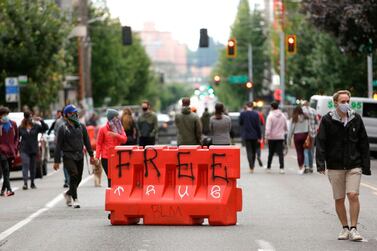 In this file photo taken on June 12, 2020 a barricade with the word "Free" painted on it is pictured in an area being called the Capitol Hill Autonomous Zone (CHAZ) located on streets reopened to pedestrians after the Seattle Police Department's East Precinct was vacated. AFP