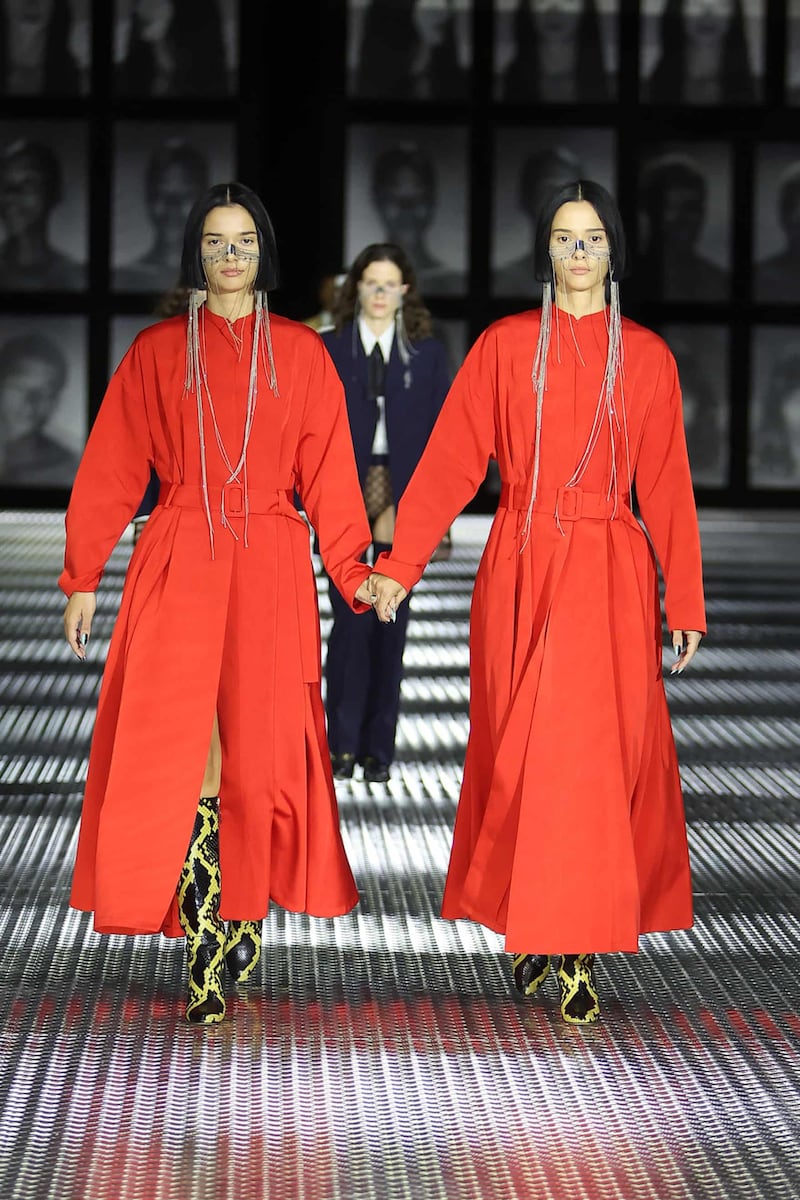 Models wore red coat dresses over leopard print boots.