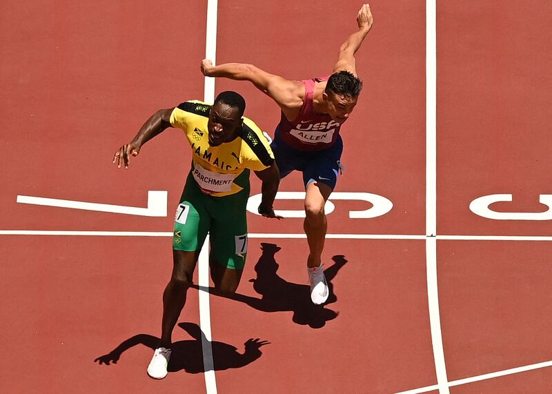 Jamaica's Hansle Parchment crosses the finish line past USA's Devon Allen to win the men's 110m hurdles final.