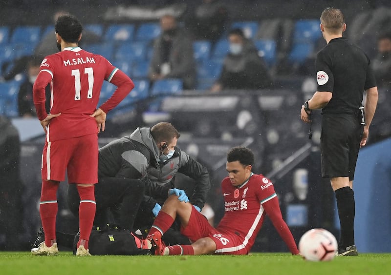 Liverpool's Trent Alexander-Arnold receives treatment after picking up a calf injury that saw him substituted in the second half. Reuters