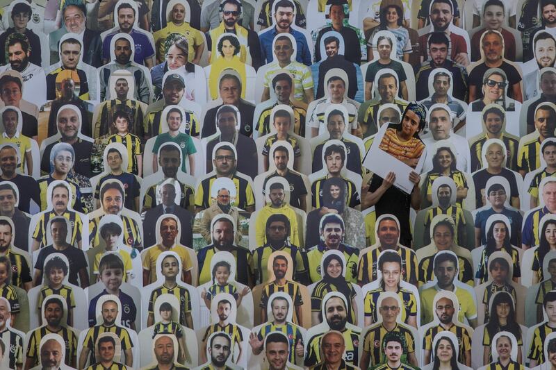 A worker installs cut-out portraits of Fenerbahce  fans at Fenerbahce Sukru Saracoglu Stadium in Istanbul, Turkey. Getty Images