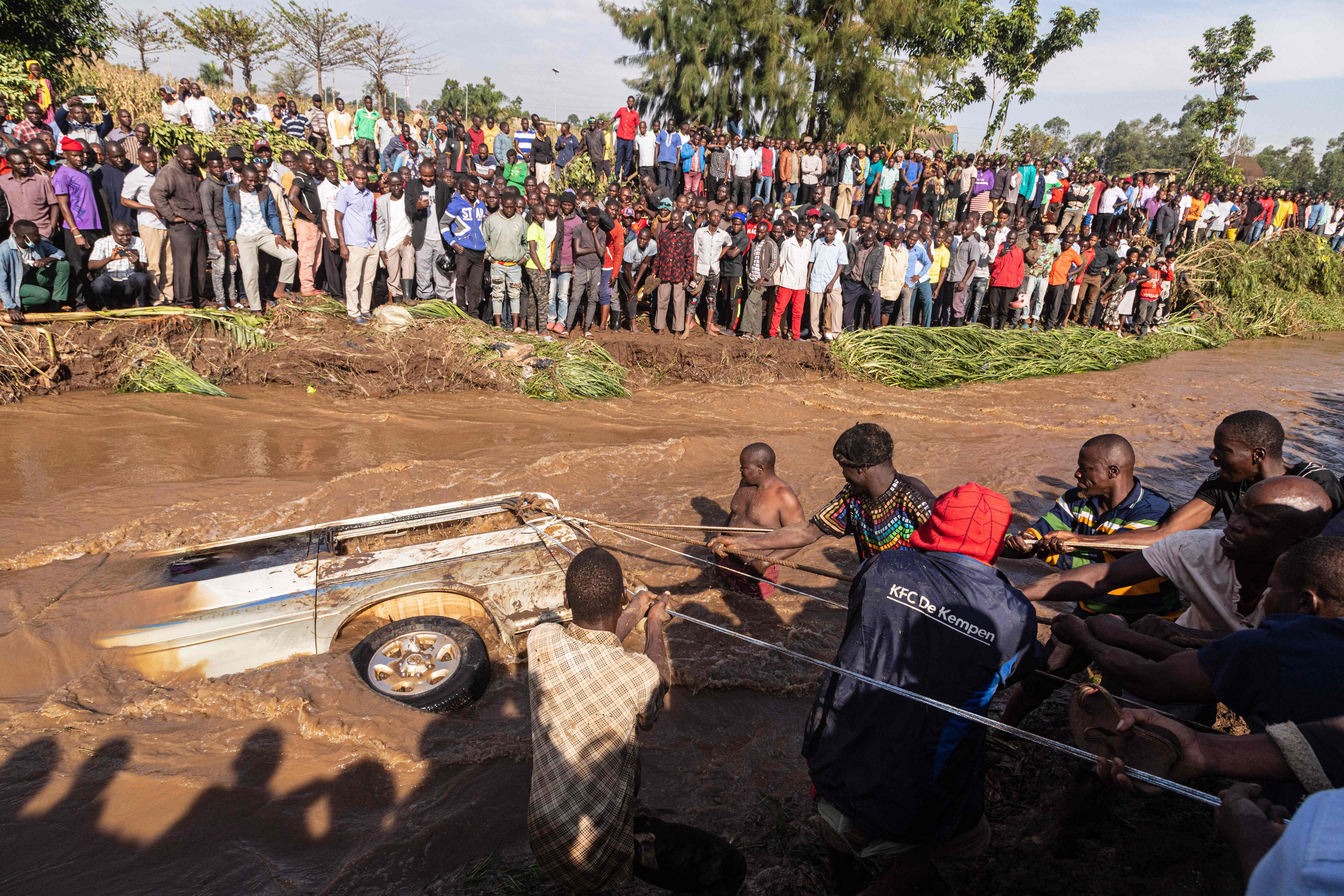 Villagers trying to pull a minibus in which 14 bodies were retrieved from the Nabuyonga river in Namakwekwe, eastern Uganda. AFP