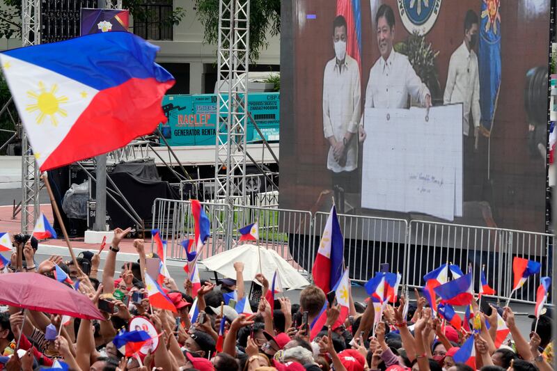 Supporters watch Mr Marcos Jr and Mr Duterte on a giant screen during the ceremony. AP