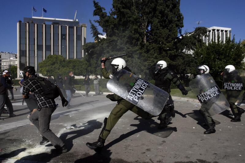 Protesters clash with riot police in Athens on October 19, 2011 as a two-day general strike began against a new austerity bill demanded by Greece's international creditors to avert bankruptcy. Over 52,000 people converged on central Syntagma Square, where parliament is located, in separate protests organised by unions but also joined by unaffiliated Greeks fed up with austerity cuts. AFP PHOTO / ARIS MESSINIS (Photo by ARIS MESSINIS / AFP)