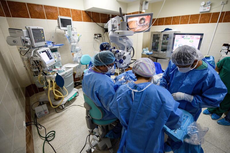 TRUJILLO, PERU - APRIL 20:  Surgeons work to remove the cataract from Obdulia, aged 60, at the IRO (Regional Institute for Ophthalmology) on April 20, 2018 in Trujillo, Peru. Having experienced visual deterioration for over three years, she was chosen for surgery during a programme run by Orbis, the ophthalmic training organisation. Founded in 1982 by ophthalmologist David Paton, Orbis trains eyecare teams across Africa, Asia and Latin America to improve the standard of eyecare in the region. As well as working in local hospitals, the charity also has a self-sufficient surgical unit on the Orbis Flying Eye Hospital, a converted McDonald-Douglas MD10 aircraft.  (Photo by Leon Neal/Getty Images)