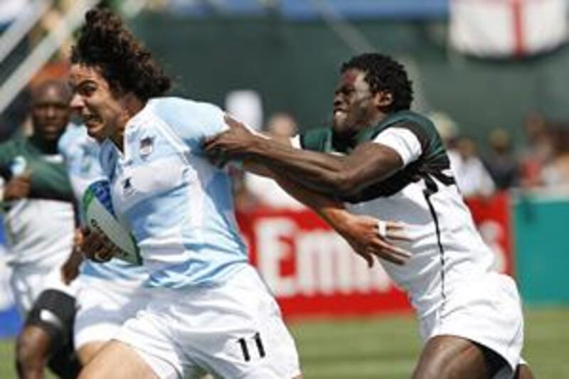 Zimbabwe's Wensley Mbanje, right, tries to tackle Argentina's Haracio San Martin.