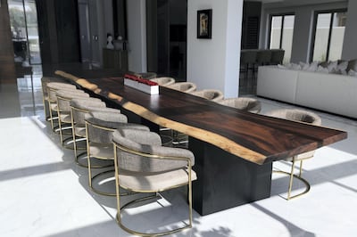 Dubai, United Arab Emirates - Reporter: Panna Munyal. Lifestyle. Homes. A table made from a single piece of wood and metal dining chairs. A peek inside a luxury home in DubaiÕs District One. Monday, February 15th, 2021. Dubai. Chris Whiteoak / The National