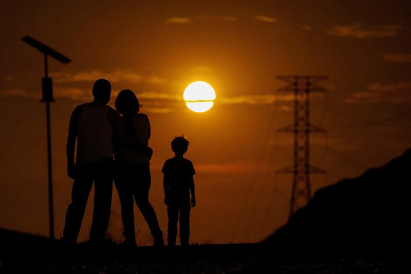 A family watches the supermoon, in Ciudad Juarez, Mexico. Reuters