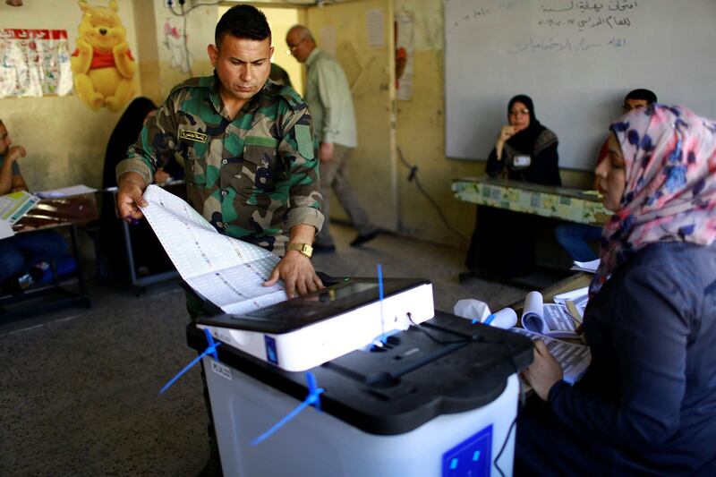 An Iraqi security member casts his vote at a polling station two days before polls open to the public in a parliamentary election in Baghdad, Iraq May 10, 2018. REUTERS/Thaier al-Sudani