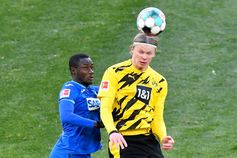 Dortmund's Erling Haaland, right, jumps for a header with Hoffenheim's Diadie Samassekou. EPA