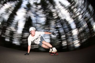 Morgan Owens rides his skateboard down a hill near Mount Shasta, California. Getty Images / AFP

