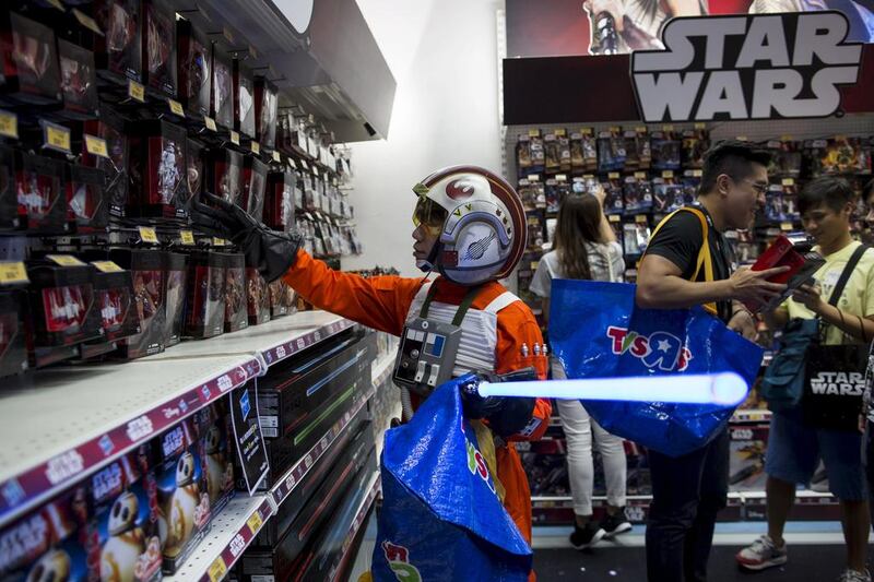 A fan dressed up as Luke Skywalker picks up new toys in Hong Kong. Tyrone Siu / Reuters