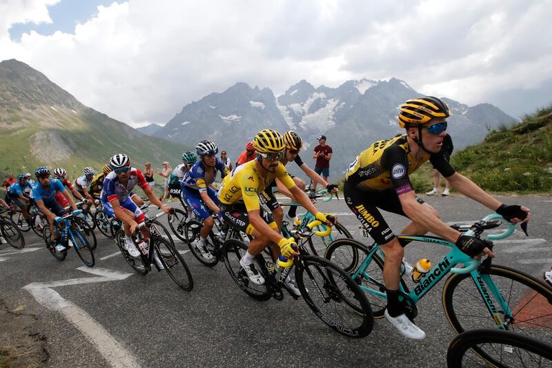 Netherlands' Steven Kruijswijk, right, France's Julian Alaphilippe wearing the overall leader's yellow jersey, center, and France's Thibaut Pinot, left, climb the Galibier pass during the eighteenth stage of the Tour de France cycling race over 208 kilometers (130 miles) with start in Embrun and finish in Valloire, France, Thursday, July 25, 2019. (AP Photo/ Christophe Ena)