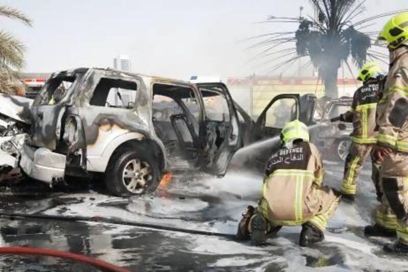 Dubai firefighters extinguish this fire resulting from a multi-car accident on Al Soufah Road near Knowlege Village in Dubai, Aug. Jeff Topping / The National
