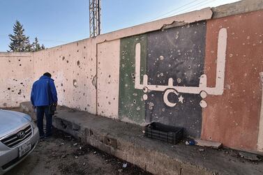 A school damaged during fighting between rival factions in Tripoli, Libya, on November 19, 2020. The writing on the wall reads "Libya" in Arabic. AFP 