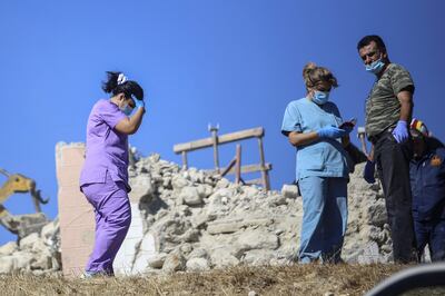 Firefighters and nurses search in Arkalochori village. AFP