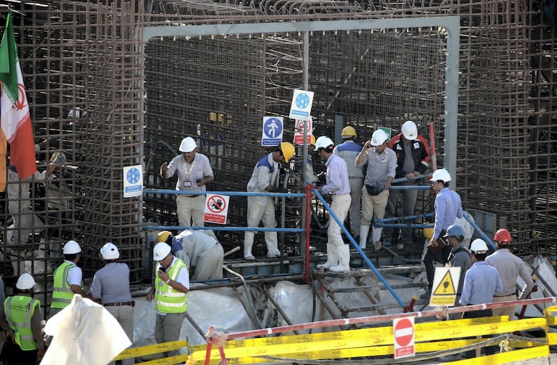 A picture taken on November 10, 2019, shows workers on a construction site in Iran's Bushehr nuclear power plant during an official ceremony to kick-start works for a second reactor at the facility. - Bushehr is Iran's only nuclear power station and is currently running on imported fuel from Russia that is closely monitored by the UN's International Atomic Energy Agency. (Photo by ATTA KENARE / AFP)