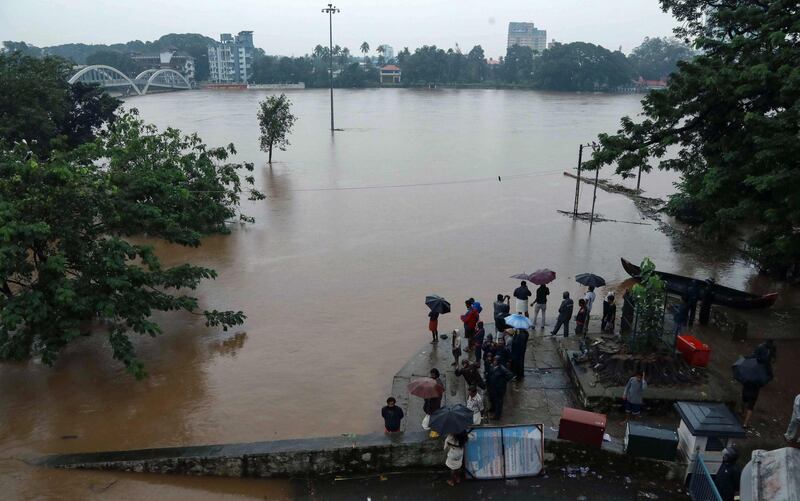 People gather on the banks of the overflowing Periyar River in the Aluva area of Kochi, Kerala, India. AFP