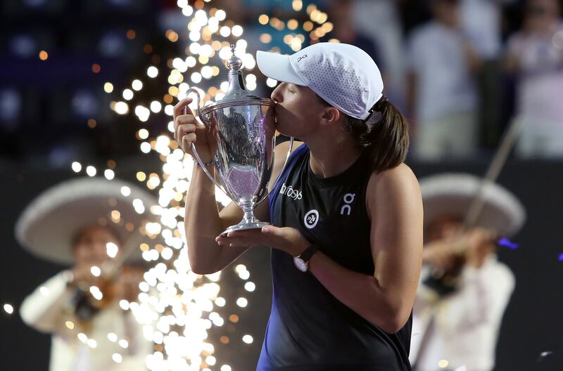 Iga Swiatek celebrates with the WTA Finals trophy after defeating Jessica Pegula in the final. EPA