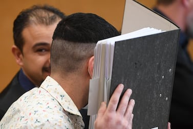 Iraqi national Taha Al Jumailly hides his face before the start of his trial in Frankfurt, Germany on April 24, 2020. AFP