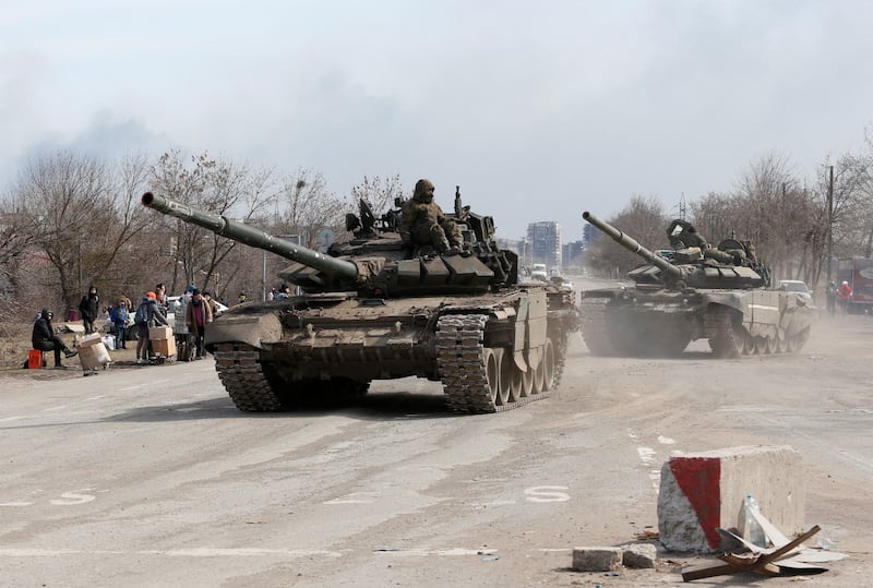 Pro-Russia militia fighters travel by tank to the outskirts of Mariupol. Reuters