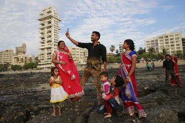 An Indian family takes a selfie on Mumbai’s coastline. India is home to the highest number of people who have died while taking photos of themselves, with 19 of the world’s 49 recorded selfie-linked deaths since 2014. Rafiq Maqbool / AP Photo