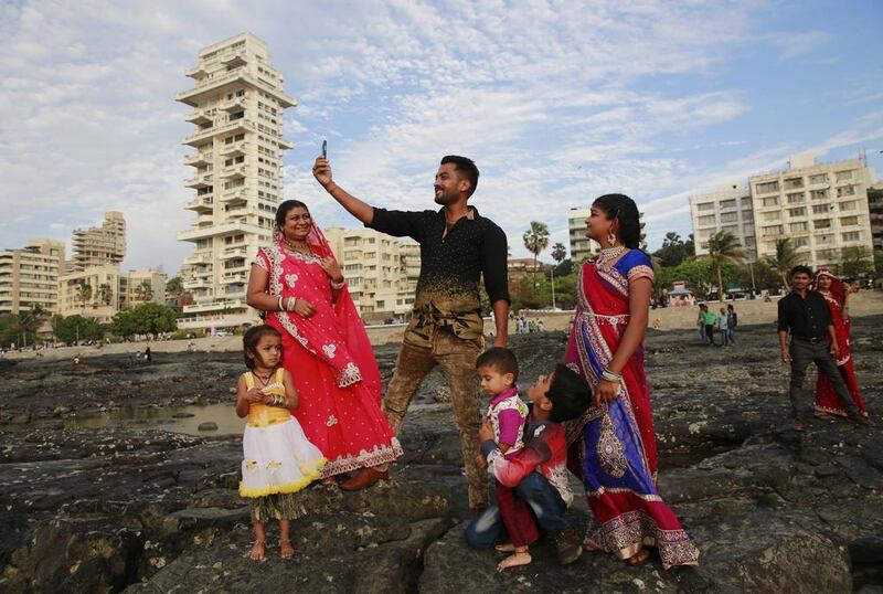 An Indian family takes a selfie on Mumbai’s coastline. India is home to the highest number of people who have died while taking photos of themselves, with 19 of the world’s 49 recorded selfie-linked deaths since 2014. Rafiq Maqbool / AP Photo