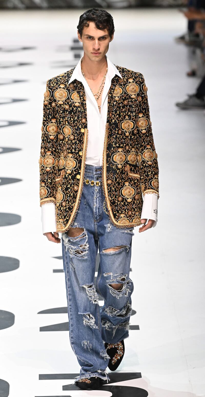 Slashed jeans and an embroidered jacket at the Dolce & Gabbana spring/summer 2023 menswear show. Photo: EPA