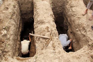 People dig graves at a cemetery where victims of Covid-19 are buried in Taiz, Yemen. Reuters, file