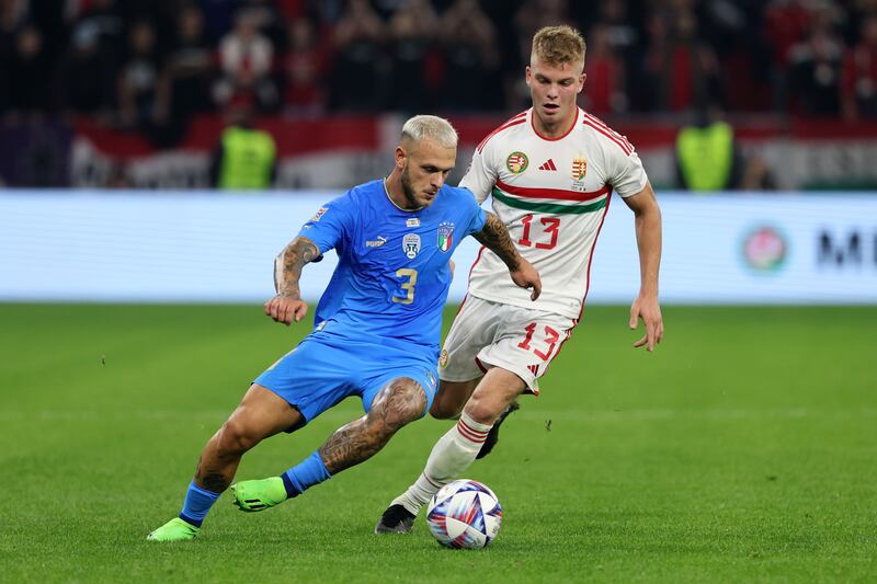 Federico Dimarco of Italy battles for possession with Andras Schaefer of Hungary.  Getty Images