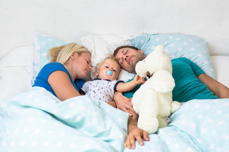 Family in bed. Getty Images