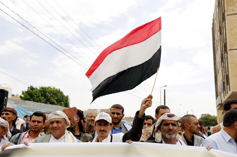 A Yemeni waves a flag during a protest against the aid suspension of the World Food Programme, outside the UN offices in Sanaa.  EPA