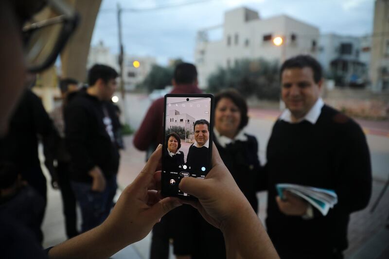 Ayman Odeh, Israeli Arab parliament member and leader of the Joint List alliance, poses for a photo with a supporter during an election campaign event in then town of Yabeh, West Bank. AP