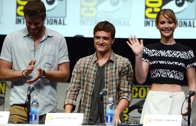 From left, Liam Hemsworth, Josh Hutcherson and Jennifer Lawrence attend the "The Hunger Games: Catching Fire" panel Day 4 of Comic-Con International on Saturday, July 20, 2013 in San Diego. (Photo by Jordan Stauss/Invision/AP) *** Local Caption ***  2013 Comic-Con - The Hunger Games- Catching Fire Panel.JPEG-09749.jpg
